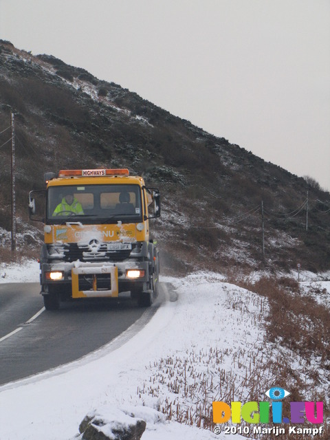 SX12145 Gritting truck driving through hillsides covered in snow